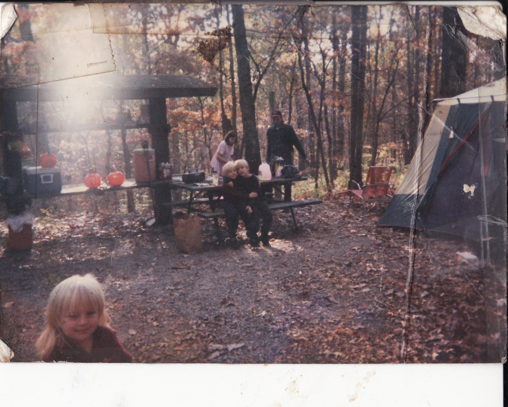 Zowie, running to me, was 11 months old when I made the decision to pursue a thoreau-like life in the woods (1993); a year before I met Greg (walking into the campsite w/ wood)